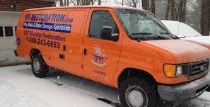 Water Damage Restoration Van At Residential Job Site